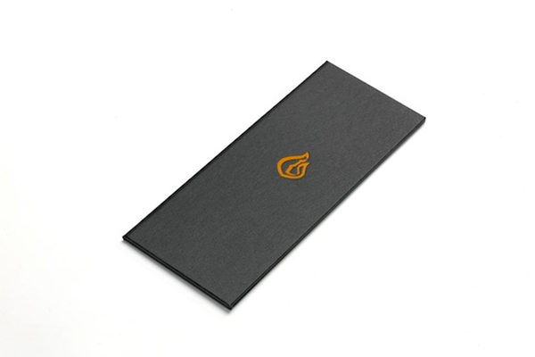 Buckram covered menu cover  with orange indented logo, created for Jamie Oliver’s restaurant in London The Fire Station.