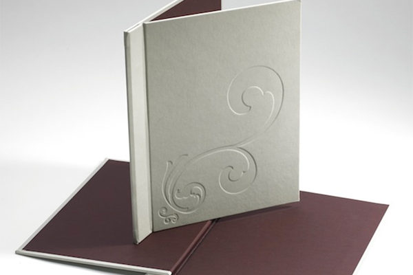 Embossed menu cover design on a 3000 micron board, elastic located inside the spine to hold A4 pages. De-bossed pattern on cover is set into the material covering offering longevity and easy cleaning.