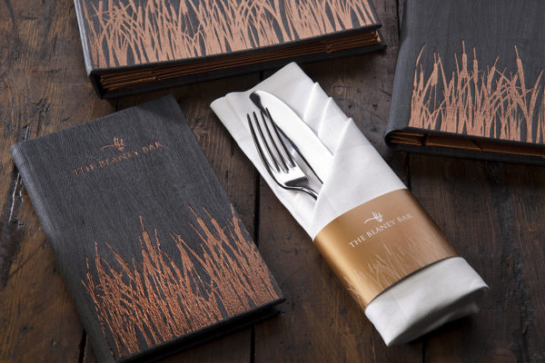 Super cool menus for a hotel bar. We used a brand new material with a copper foil block to add the reed effect.
